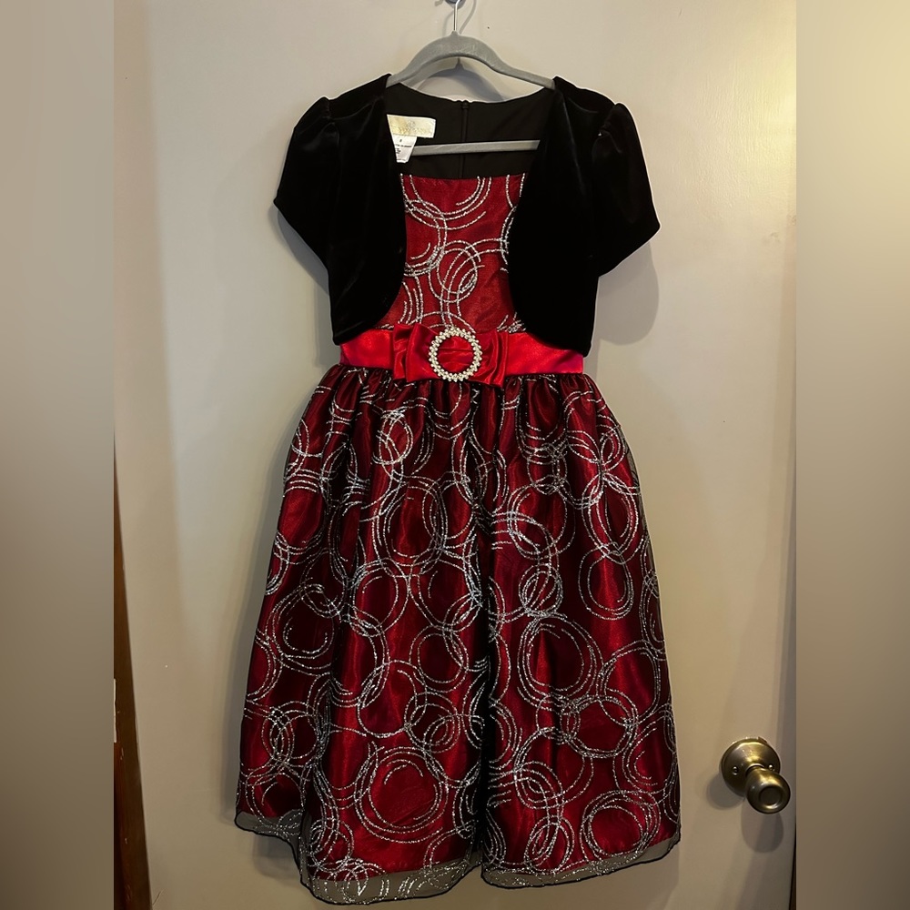 Size 8. Red dress w/black mesh. Silver glitter design.  Belt w/rhinestones.